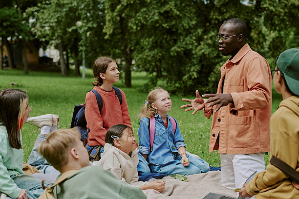 istock Diverse School Teacher Engaging Multiethnic Children during Outdoor Lesson 2226596236