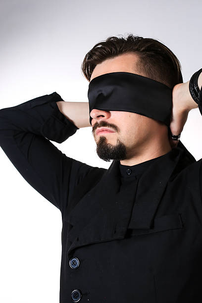 istock A man with his eyes blindfolded. Studio photo. High quality photo 2226599315