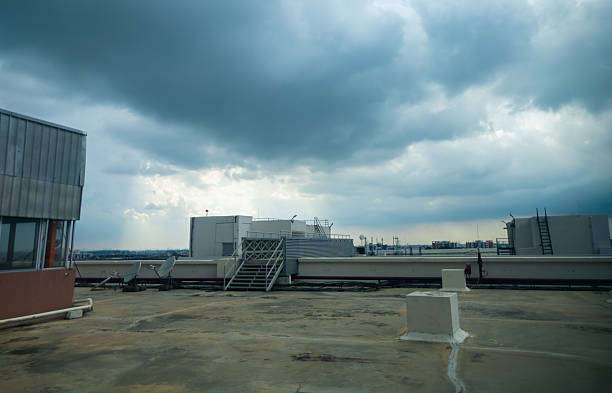 istock Urban rooftop scene in Bengaluru, India, showing building structures, satellite dishes, and dramatic cloudy sky. 2226599596