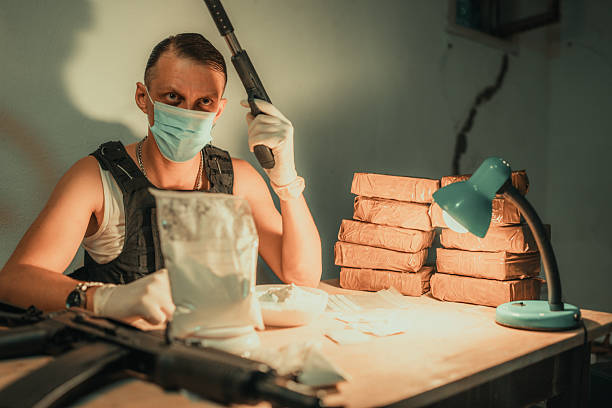 istock Person Preparing Substances in Dark Room with Concealed Identity 2226601068