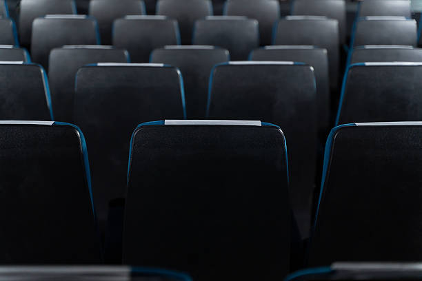 istock Blue chairs in an empty movie theater, low light 2226601696
