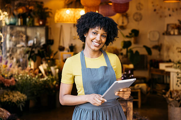 istock Florist owner smiling and using digital tablet in flower shop 2226602080