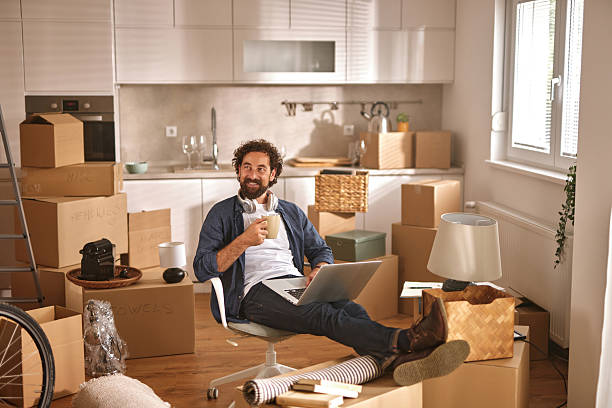 istock Man relaxing with coffee and laptop in new home 2226603657