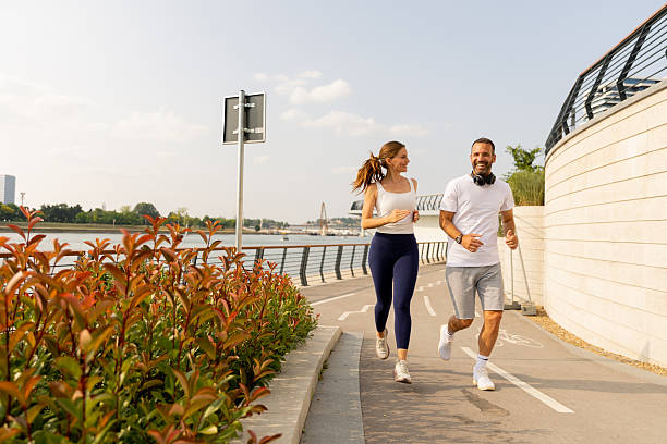 istock Couple enjoys a joyful run along the scenic waterfront path on a sunny afternoon 2226603674