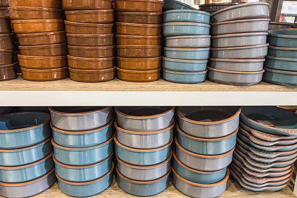 Stacks of ceramic bowls on a store shelf.
