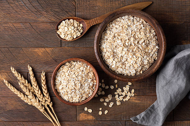 istock Oat grains, rolled oats in wooden bowl 2226606192