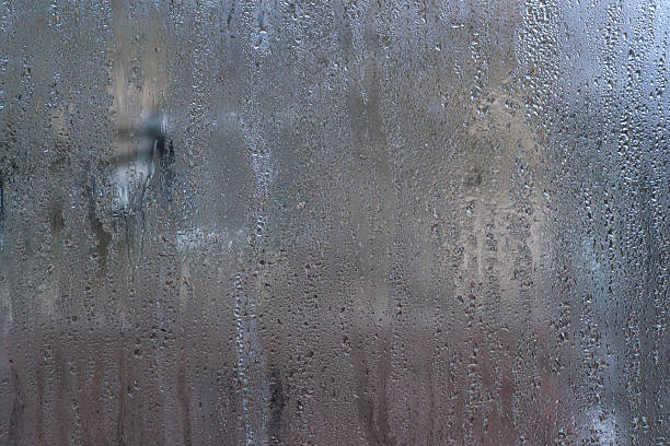 istock wet glass. Tiny water droplets blanket fogged glass. some droplets. 2226607728