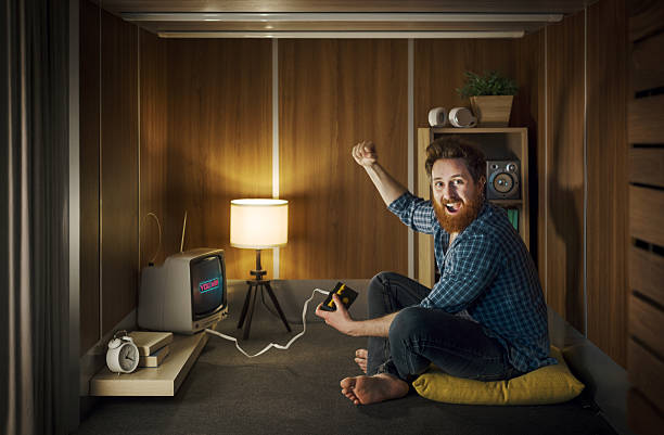 istock Cheerful man playing video games in a tiny living room 2226607834