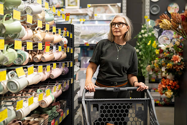istock Woman shopping in a hypermarket while selecting home goods and decor items with genuine emotions 2226608109