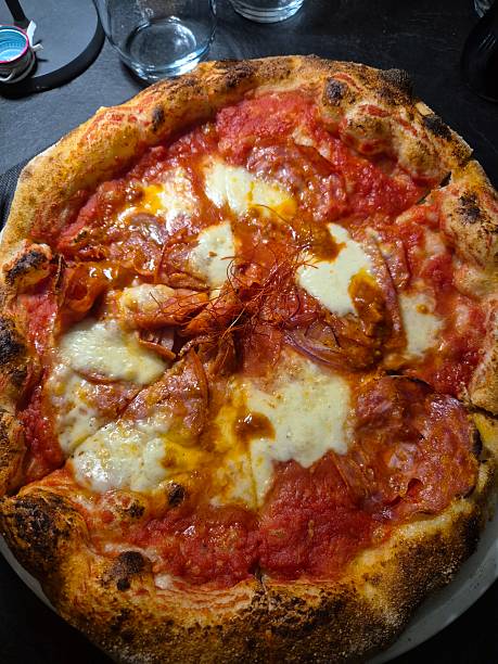 istock pizza with tomato, mozzarella, spicy salami and chili pepper 2226608204