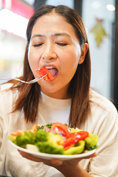 istock Woman eating a delicious vegetable salad 2226608741