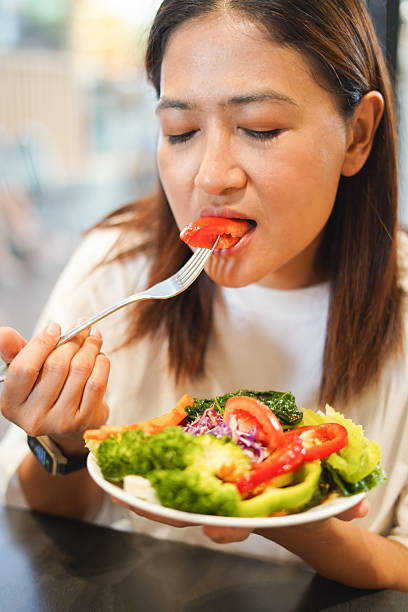 istock Woman eating a delicious vegetable salad 2226608763