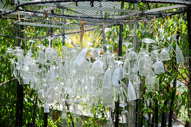 A bunch of used glasses hanging upside down for abstract park decoration.