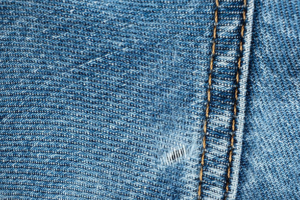istock Hole in cotton denim, frayed threads 2226609997