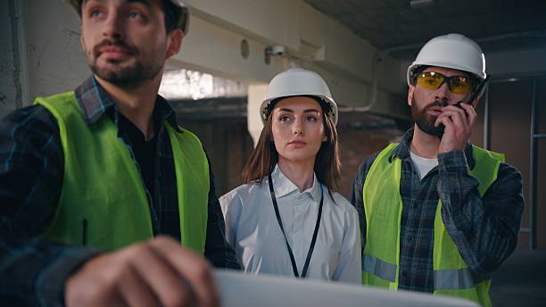 istock Caucasian men woman workers colleagues discussing talking building plan construction paper project teamwork architects males female civil engineers architecture blueprints coworkers business builders 2226613397