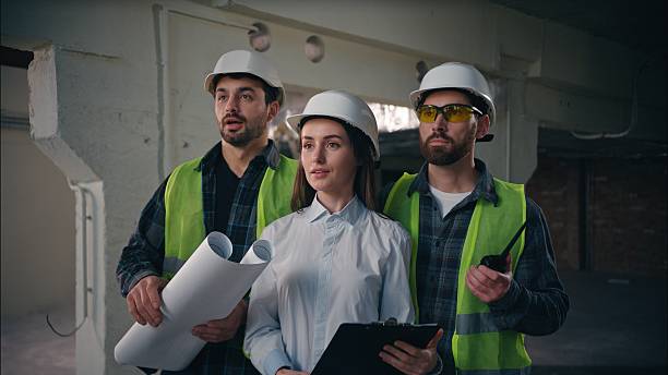 istock Three surprised Caucasian men builders woman inspectors engineers in construction technicians working awe emotion foremen shock manufactory architects looking admire finished work manufactory success 2226613593