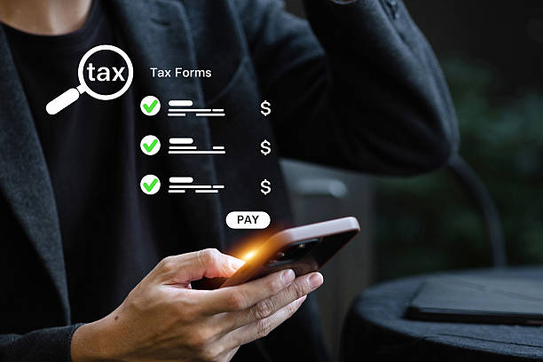 istock A man reviews and prepares to pay his taxes using a mobile phone interface that lists digital tax forms. 2226614350