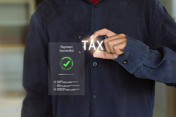 A hand interacts with a holographic interface showing TAX and a Payment Successful notification, symbolizing a completed tax payment.