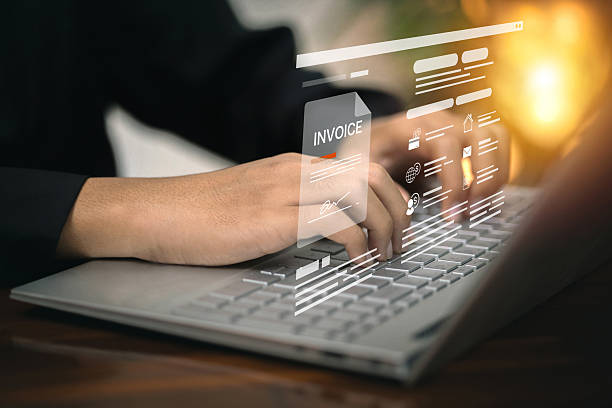 istock A person types on a laptop while interacting with a digital invoice on a holographic interface, representing online billing. 2226614704