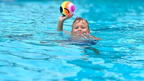 istock A boy is playing ball in a swimming pool 2226616946
