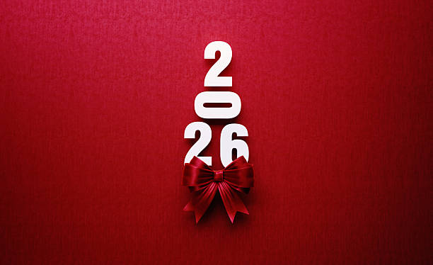 istock 2026 Text Forming A Christmas Tree with Red Bow Tie on Red Background 2226617014