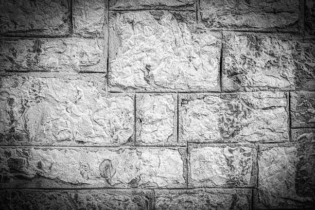Black and White Stone Wall Texture with Intricate Details. Vignette Effect.