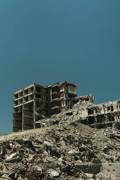 istock destroyed high-rise apartment building surrounded by wreckage and rubble 2226619365