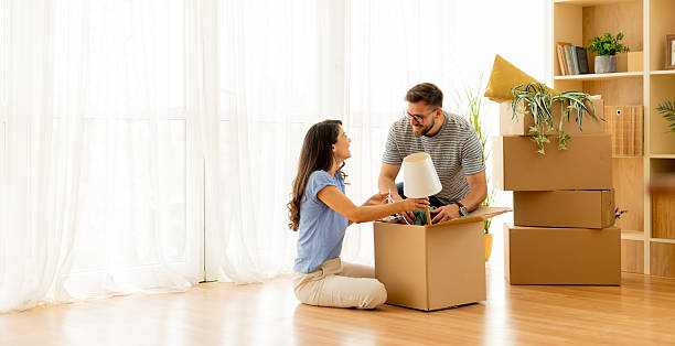 istock Couple joyfully unboxing their new home decor during a sunny afternoon 2226620322