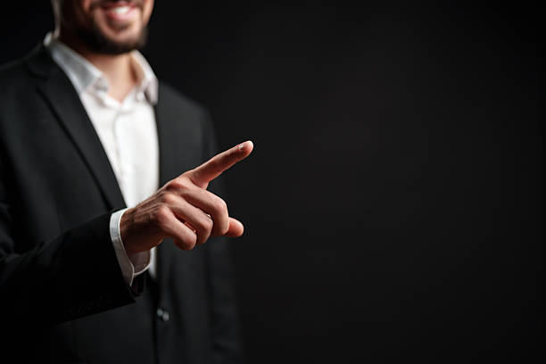 istock Businessman gesturing positively during a corporate presentation in a dark studio setting 2226623759