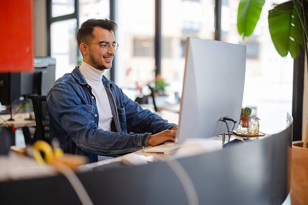 istock Young businessman working on computer in modern office 2226624288