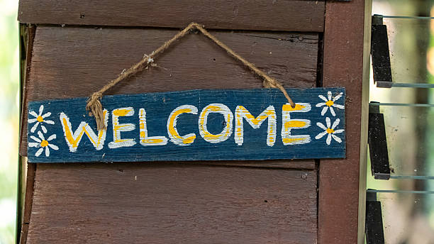 istock Hand-painted wooden welcome sign hanging on a rustic wall 2226624498
