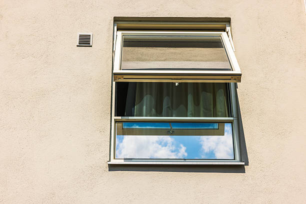 istock Open glass window with curtain and sky reflection on beige villa wall under sunny daylight. Sweden. 2226625250