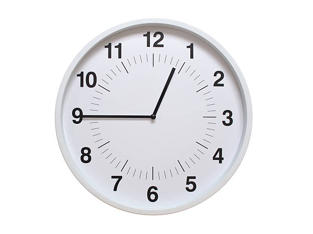 Simple white analog wall clock showing exactly 00:45 or 12:45. suitable for concepts like deadline, start or end of time. Isolated on a clean white background.