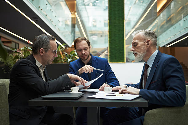 istock Business Professionals Discussing Contracts in Modern Office 2226627861