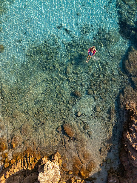 istock Person Floating in Clear Rocky Shallow Water 2226629824