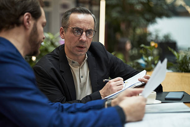 istock Male Managers Discussing Business Strategies in Office Setting 2226630082