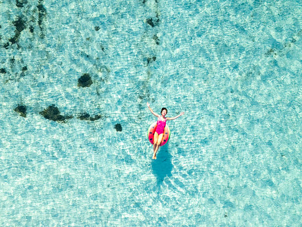 istock Woman Relaxing on Watermelon Float in Pool 2226630497