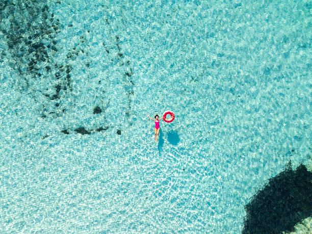 istock Woman Floating in Clear Blue Ocean Water 2226630631