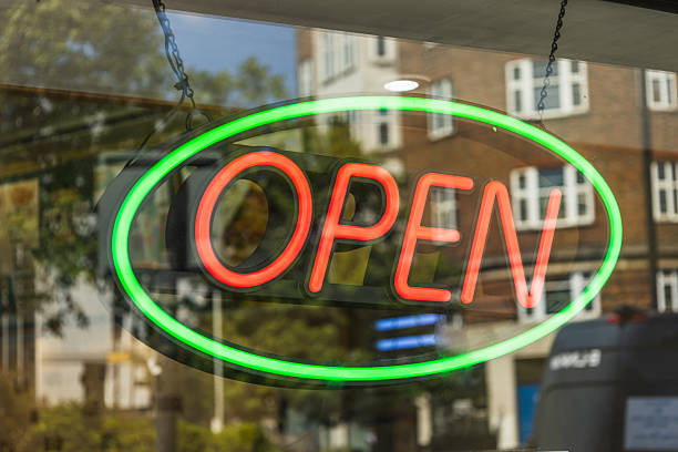 istock Bright neon OPEN sign in shop window with green oval border 2226630737
