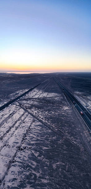 istock A Highway Through a Snowy Landscape at Dusk 2226631293