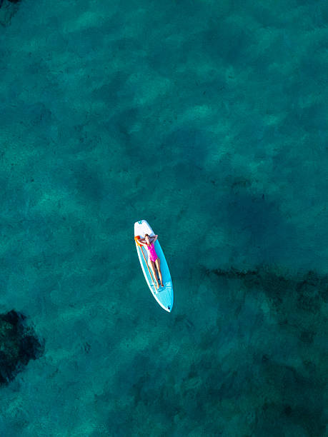 istock Woman Relaxing on Paddleboard in Clear Water 2226631395