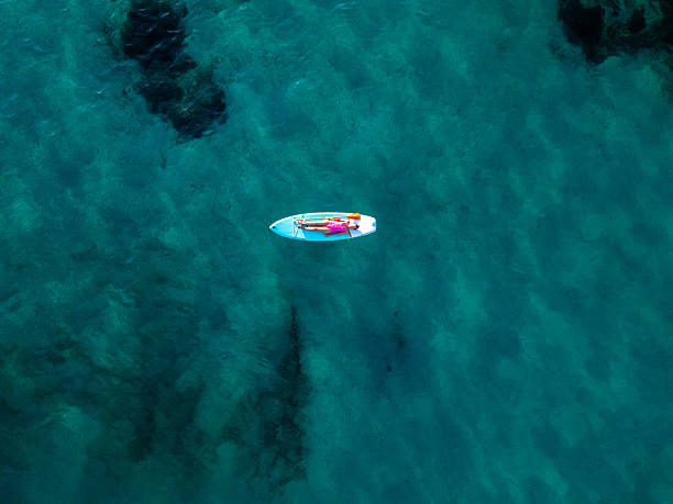 istock Woman Relaxing on Paddleboard in Clear Water 2226631403
