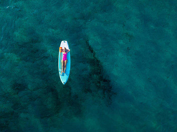 istock Woman Relaxing on Paddleboard in Clear Water 2226631441
