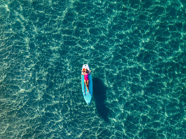 istock Woman Relaxing on Paddleboard in Clear Water 2226631668