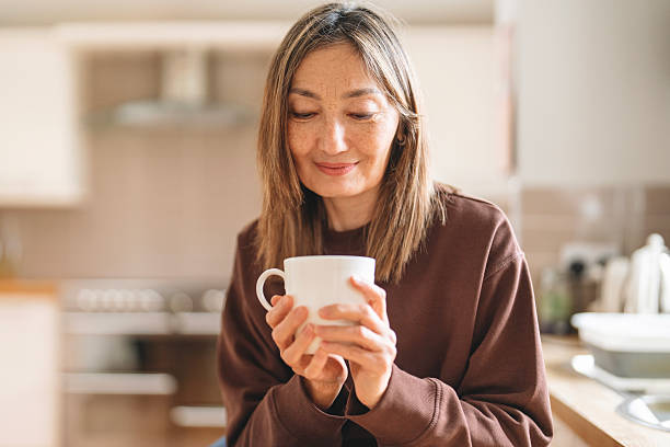 Enjoying a warm beverage in a cozy kitchen during a relaxed morning routine while reflecting on the day ahead