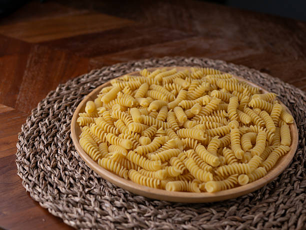 Raw Fusilli Spiral spaghetti pasta pattern background.