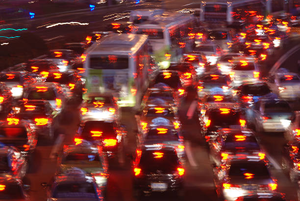 Busy traffic through downtown at night. Image entirely blurred.