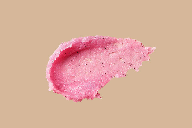 istock Smear texture of pink raspberry scrub on brown background. Fruit exfoliation scrubber for body and face in SPA. Swatch of body care scrub for design. 2226637246