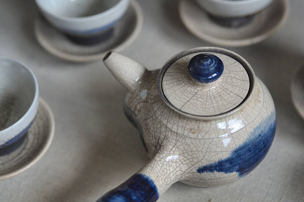 Elegant Ceramic Teapot and Teacups with Blue Accents