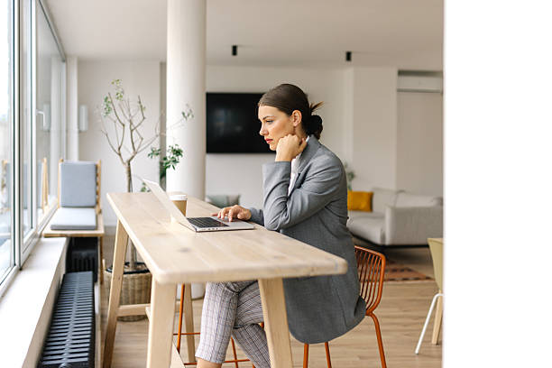 istock Female professional working on a laptop at a desk 2226637440
